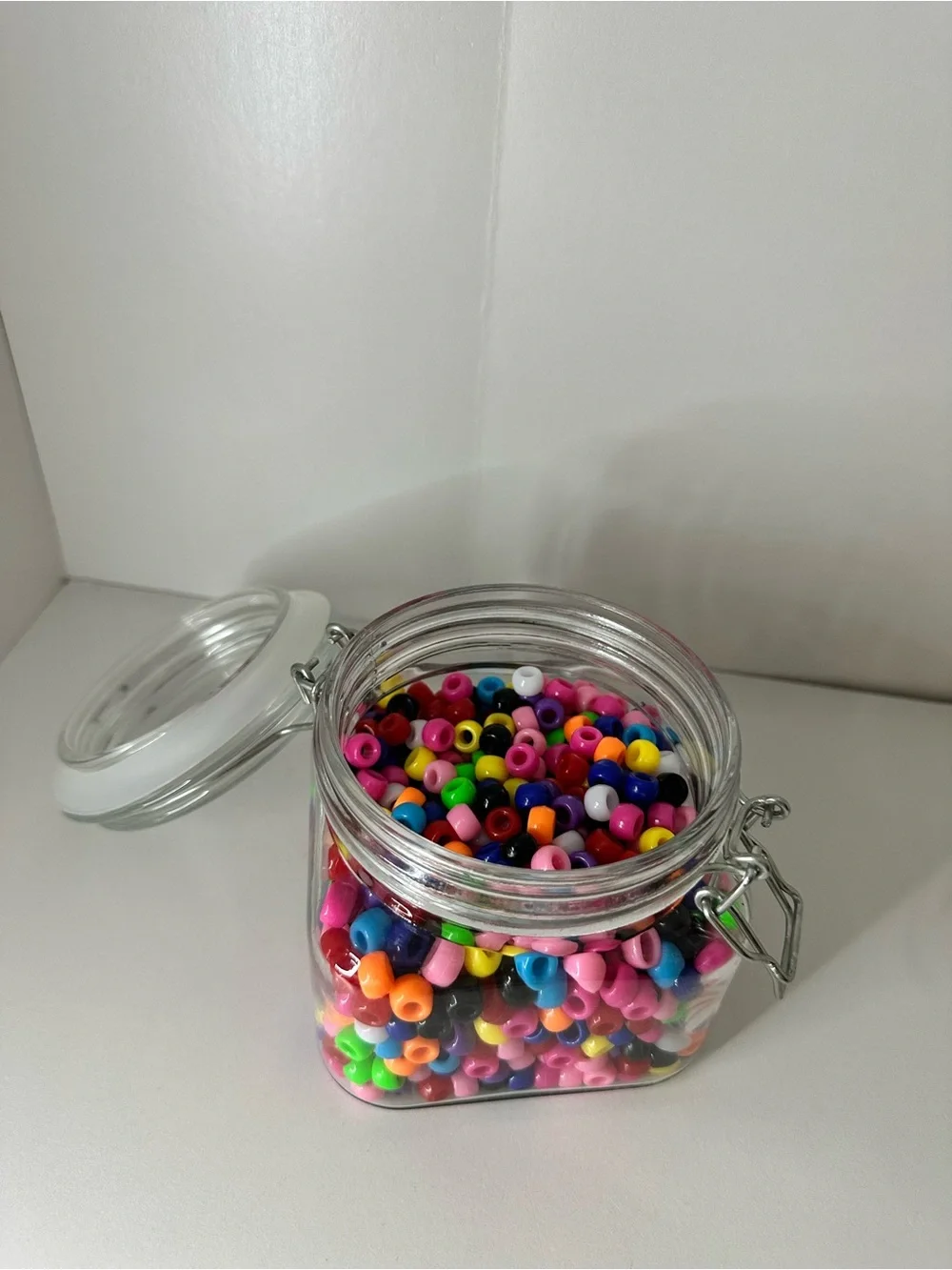 Multi Colored Beads in Clear Glass Airtight Storage Jar with Metal Clamp